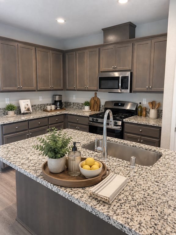 A kitchen with granite countertops and a sink.
