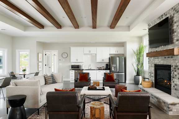 A modern living room with a fireplace and a dining table.