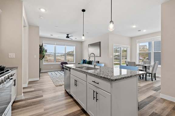 a kitchen with a counter top and a dining room