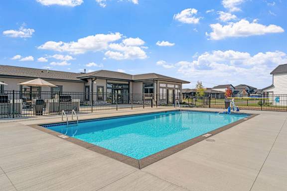 a swimming pool with a building in the background