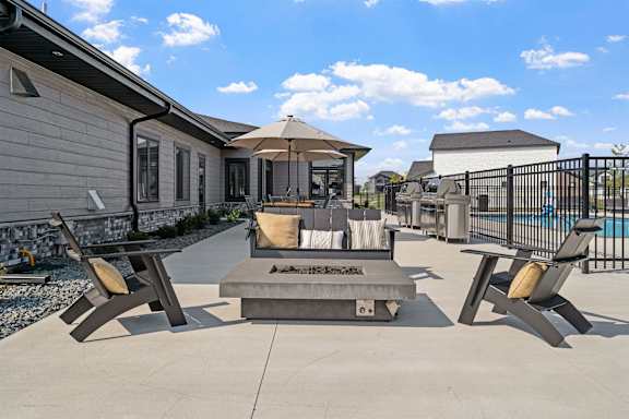 the estates at tanglewood  outdoor patio area with fire pit and seating area
