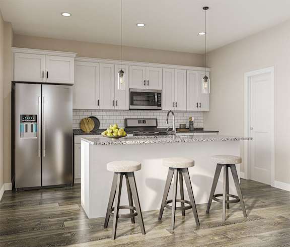 a kitchen with white cabinets and a bar with three stools