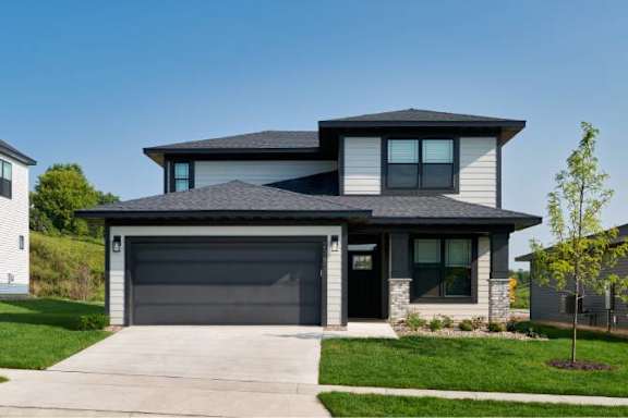 a house with a garage door in front of it