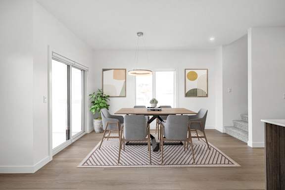 A dining room with a table set for four.