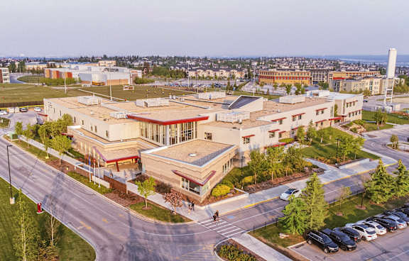 A large building with a parking lot in front of it.