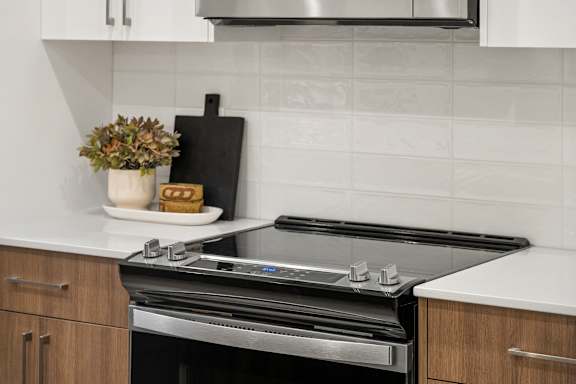A modern kitchen with a black stove top oven.