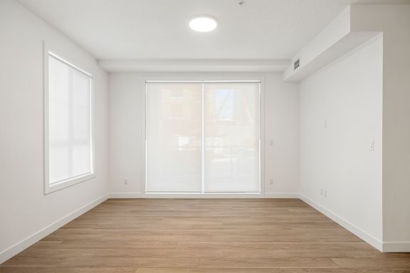 A room with a window and a sliding glass door.