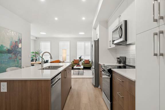 A modern kitchen with wooden cabinets and stainless steel appliances.