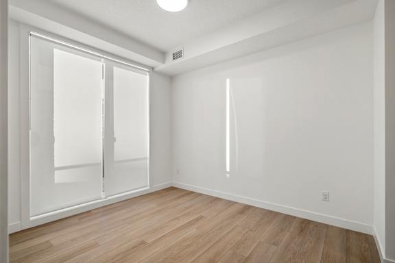 A room with a sliding door and a window.
