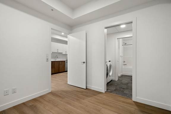 A white door is open to a bathroom.