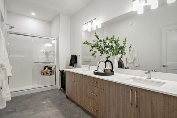 A bathroom with a white sink and a mirror.