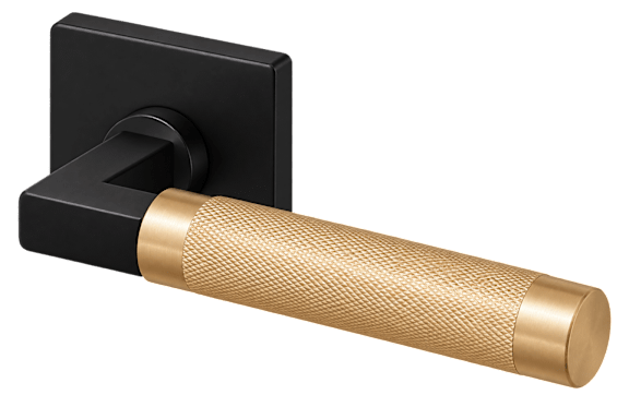A black door handle with a gold-colored grip.