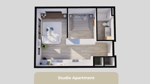 A studio apartment is shown with a bed, a desk, and a kitchenette.