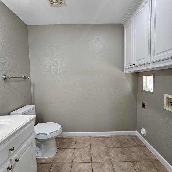A white bathroom with a toilet and sink.