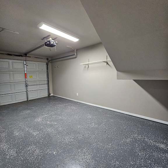 A small room with a door and a light on the ceiling.