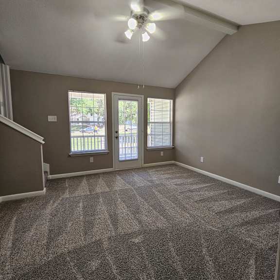 A staircase with a carpeted wall on the side.