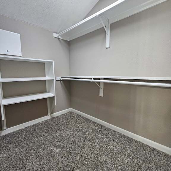 A white stairwell with a metal railing and a white box on the floor.