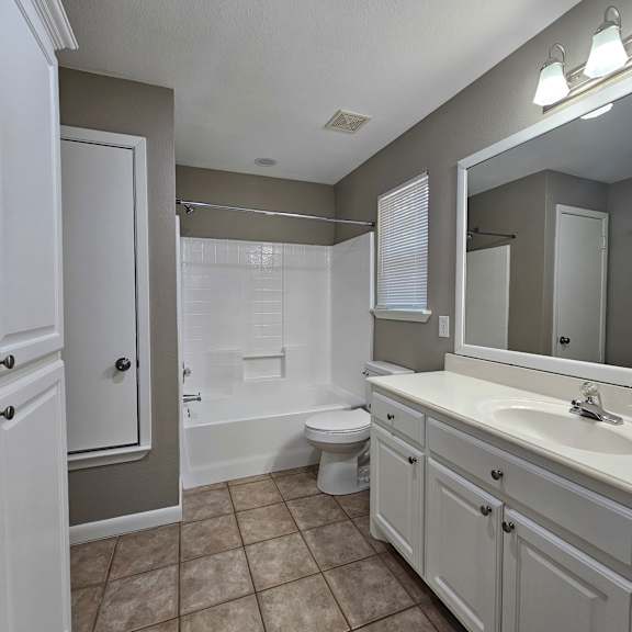 A white bathroom with a walk in shower.