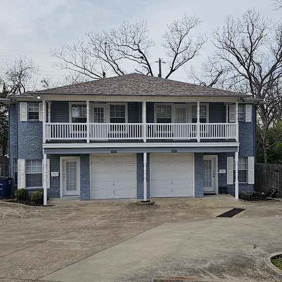 A blue house with a white garage door.