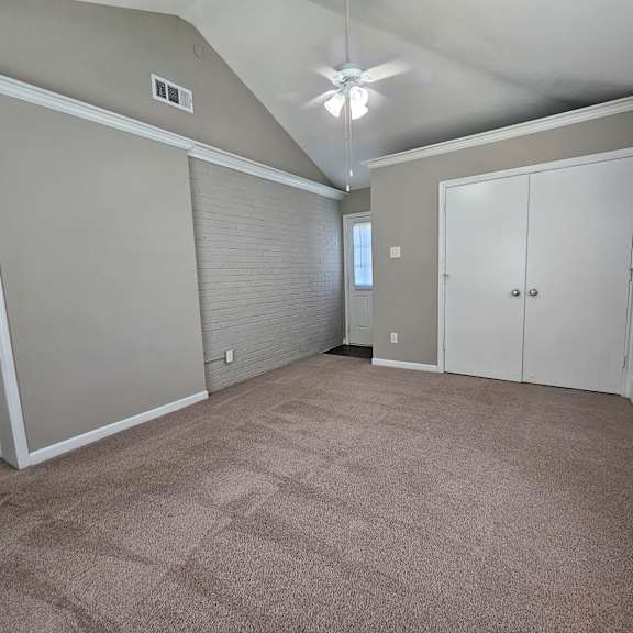 A room with a ceiling fan and carpeted floor.
