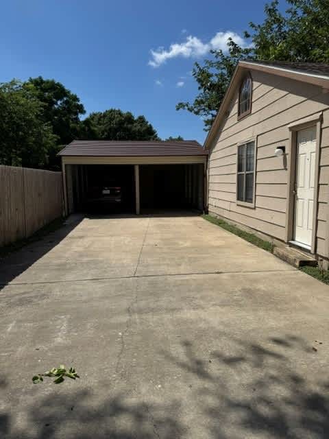 A detached house with a garage and a driveway.