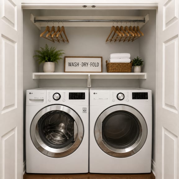 Two washing machines in a laundry room with a sign that says "Wash Dry Fold".