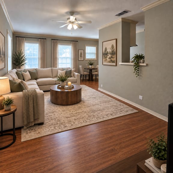 A living room with a white couch, a wooden coffee table, and a ceiling fan.