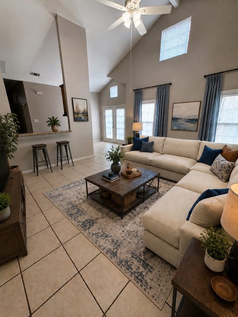 A living room with a white couch and a coffee table.