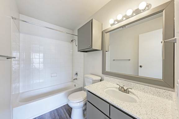 A white toilet sits next to a sink in a bathroom.