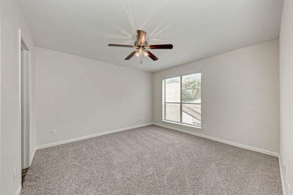 A room with a ceiling fan and a window.