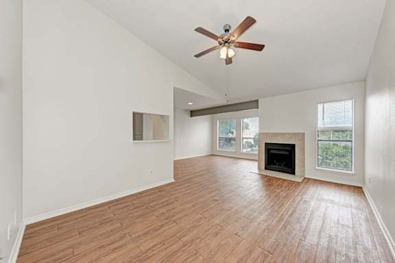 A room with a fireplace and a ceiling fan.