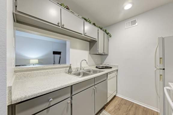 A kitchen with a sink and a window.