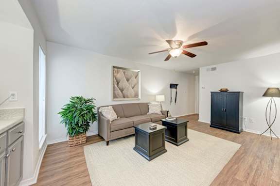 A living room with a ceiling fan and a couch.