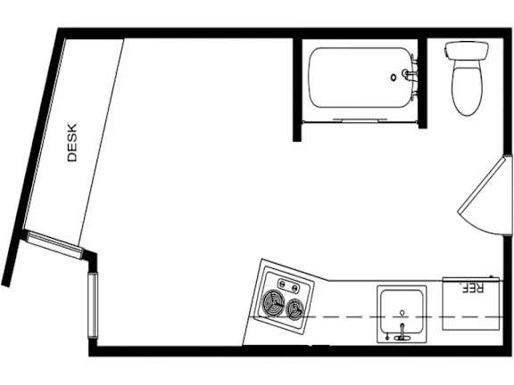 A black and white drawing of a room with a desk and a bathroom.