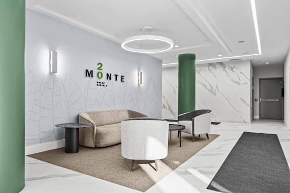 A modern waiting area with a green pillar and a white couch.