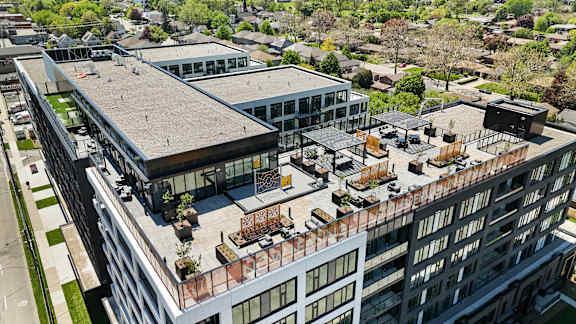 A modern building complex with a mix of residential and commercial spaces.