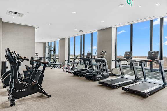 A gym with treadmills and exercise bikes.