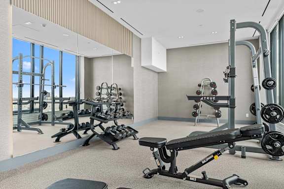 A gym with a variety of equipment including a rowing machine.