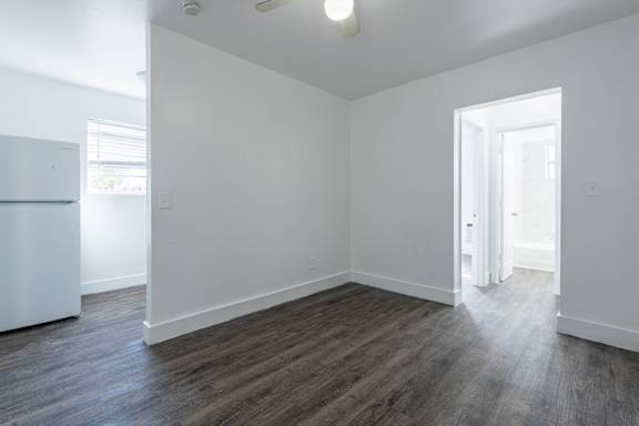 A room with a white wall and a white door.