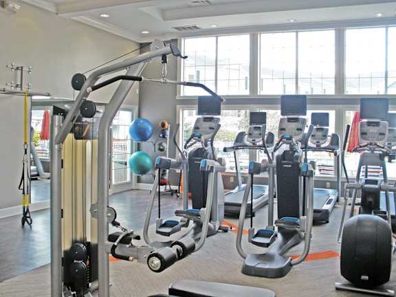 A gym with a variety of equipment including weights and machines.