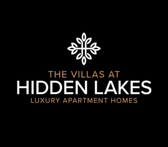 The image is a logo for The Villas at Hidden Lakes, a luxury apartment home.