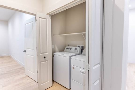 A small laundry room with a washer and dryer.