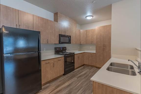 Kitchen with Black Refrigerator at Sandyplace Apartment Homes, Sandy, OR