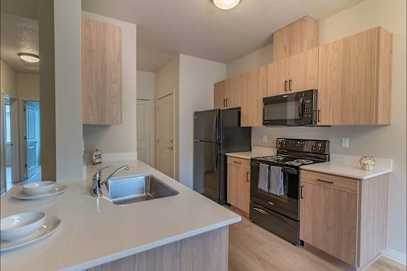 Kitchen with cabinets at Woodburn Place Apartment Homes, Woodburn, OR