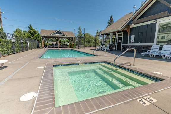 A large outdoor swimming pool with a smaller pool in the middle.