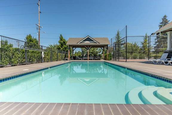 A swimming pool with a gazebo in the middle of it.