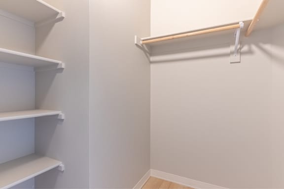 A white shelving unit with a white wall behind it.
