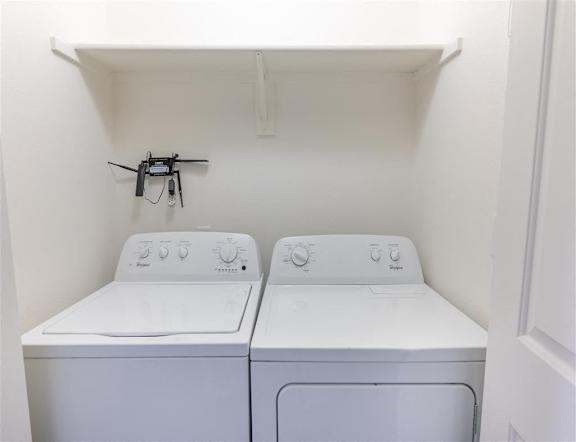 Two white machines in laundry room at Stoneplace Apartment Homes, Molalla, 97038