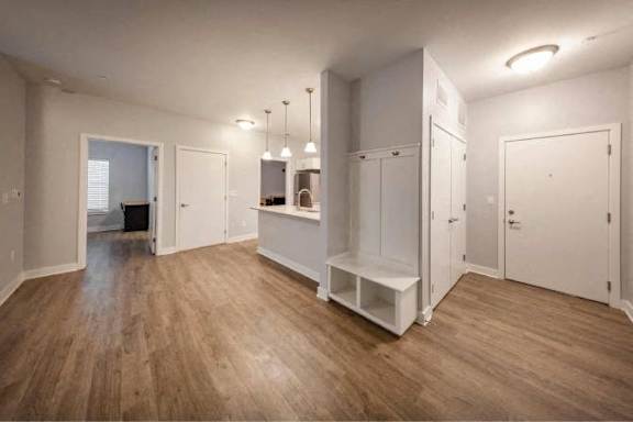 A room with wooden floors and white walls.