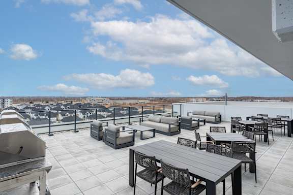 A rooftop patio with furniture and a view of the city at Damask, Windsor, ON